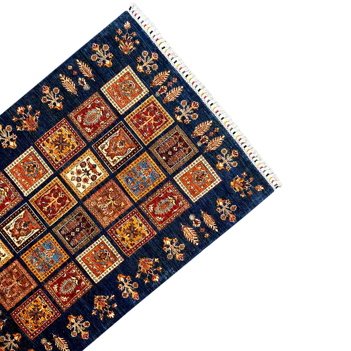Side view of a wool Khorjin rug: blue with orange-red square motifs and fringes