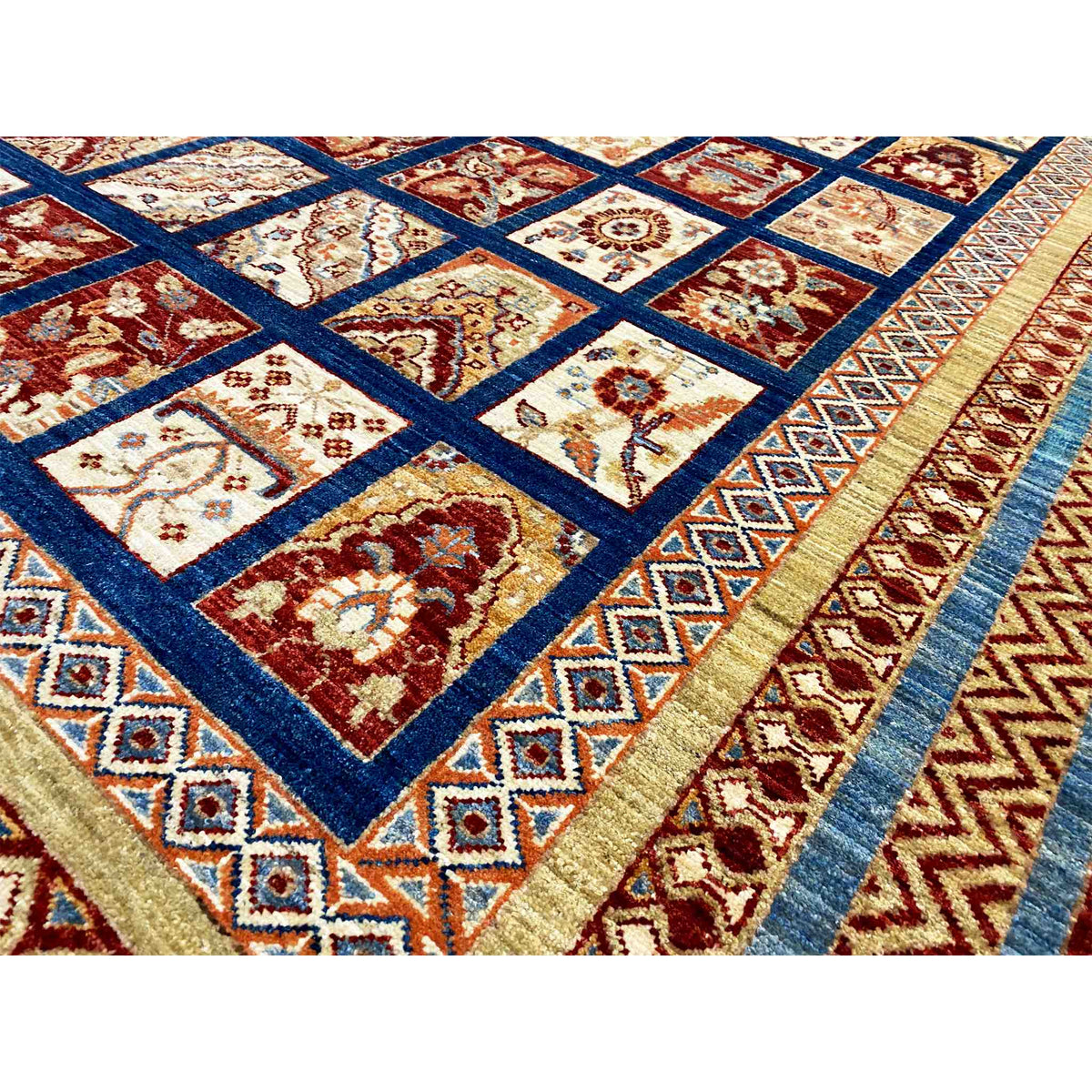 Khorjin rug detail view: square motif and zigzag border, dark blue, red, beige, turquoise