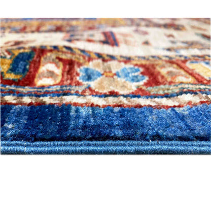 Carpet detail: dense pile with a blue border and colorful patterns