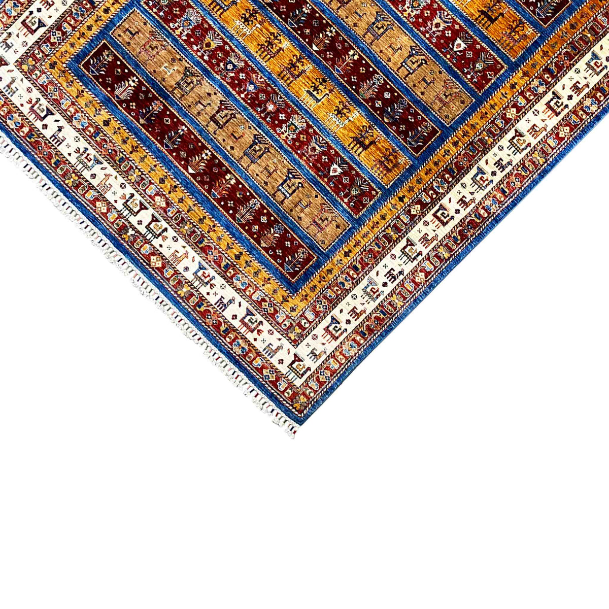Rug corner with fringed edges and geometric motifs in blue and red