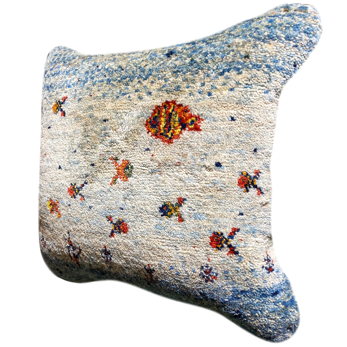 Light blue/white cushion cover with colorful ornaments, three-quarter view