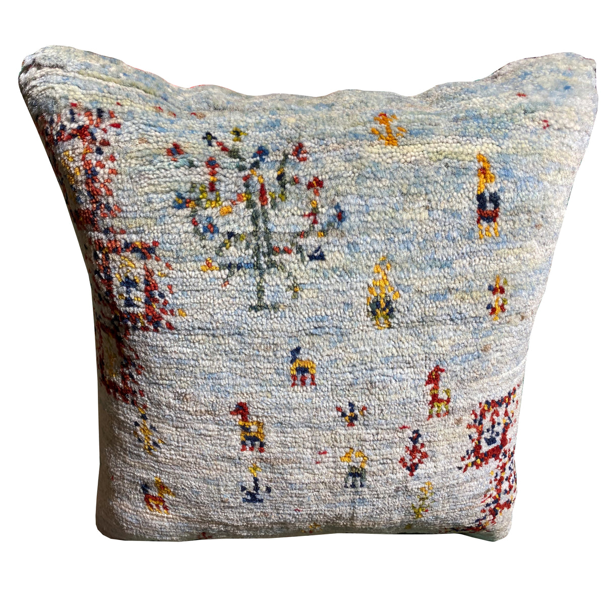 Light blue decorative cushion with colorful embroidered figures on the front