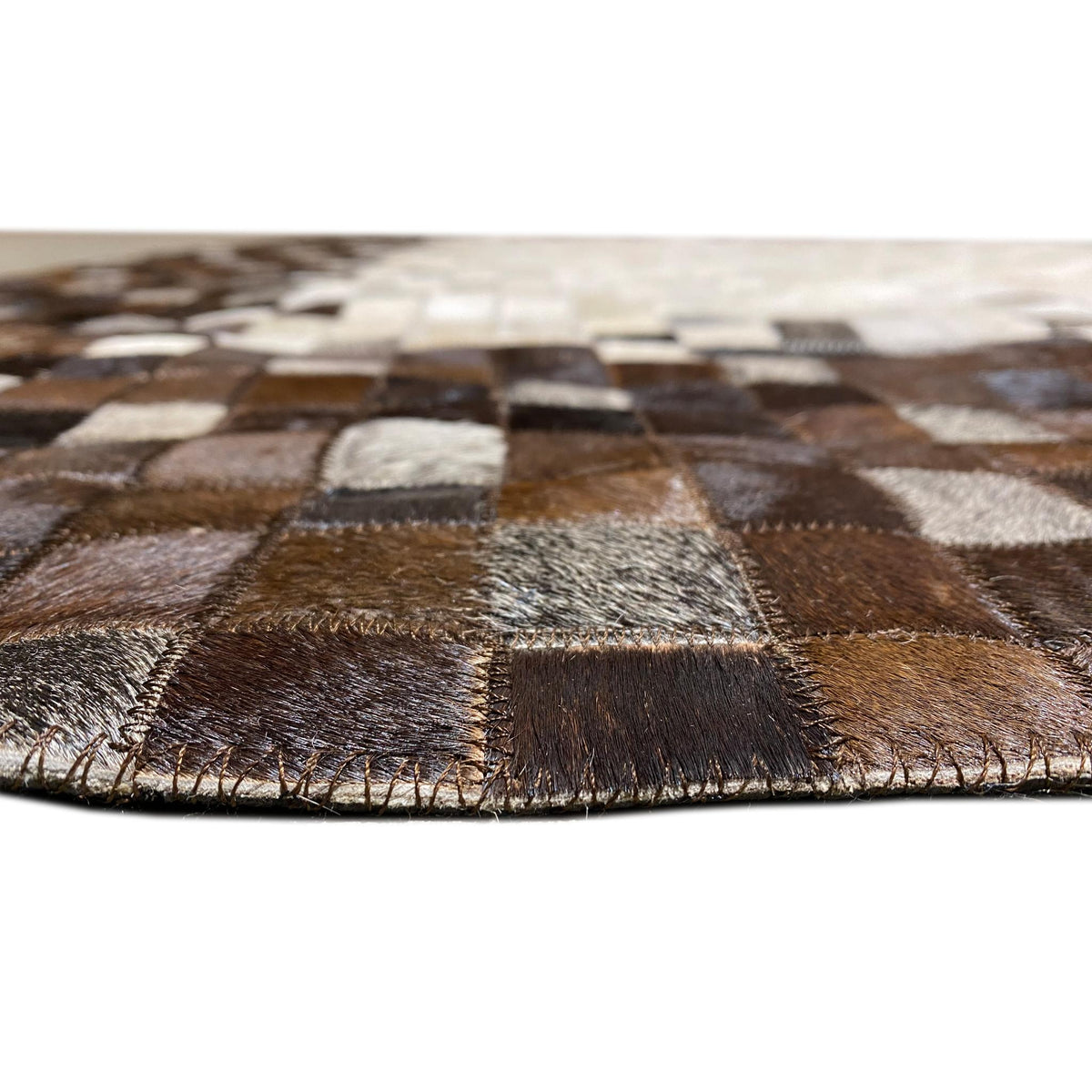 Calfskin rug edge area with fine brown fringes and patterned sections