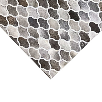 Calfskin rug corner with a lattice pattern of gray and white shapes