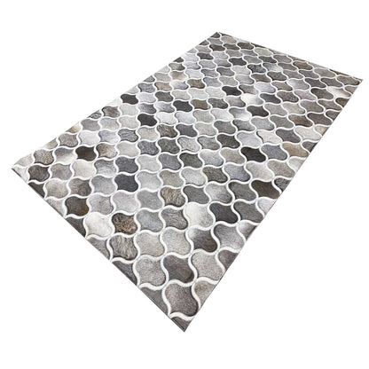Calfskin rug with a diagonal design, varying shades of gray in a geometric grid