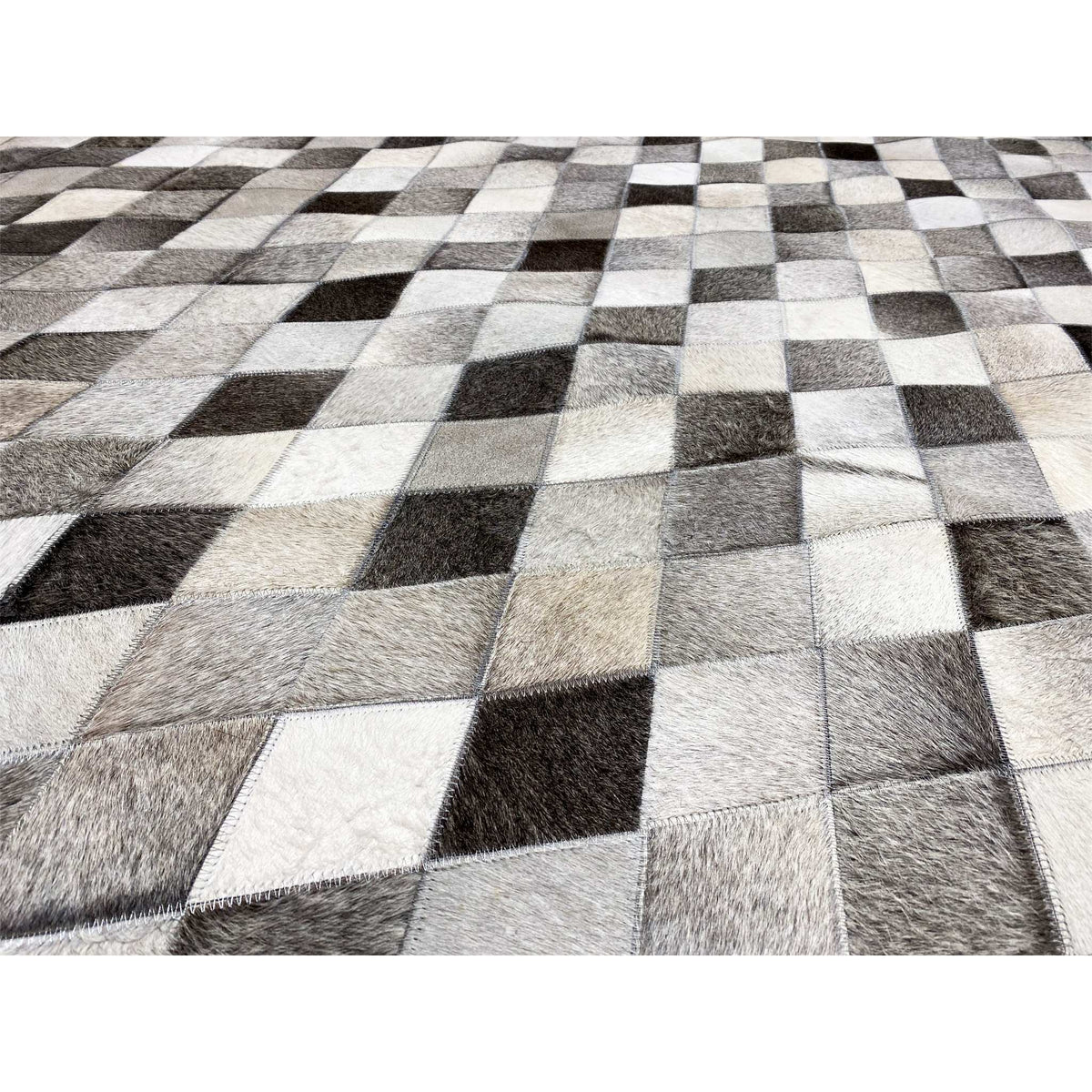 Detail of the leather rug: diamond pattern with fur texture in black, gray, and white