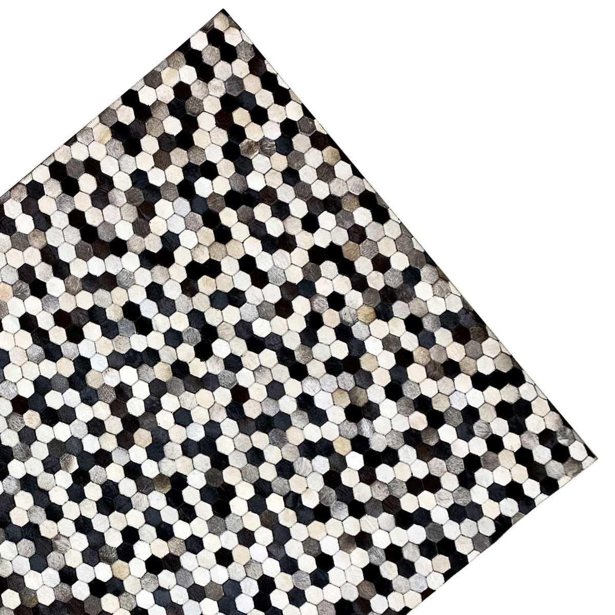 Rectangular calfskin rug with a diagonal view and hexagon pattern in black and beige