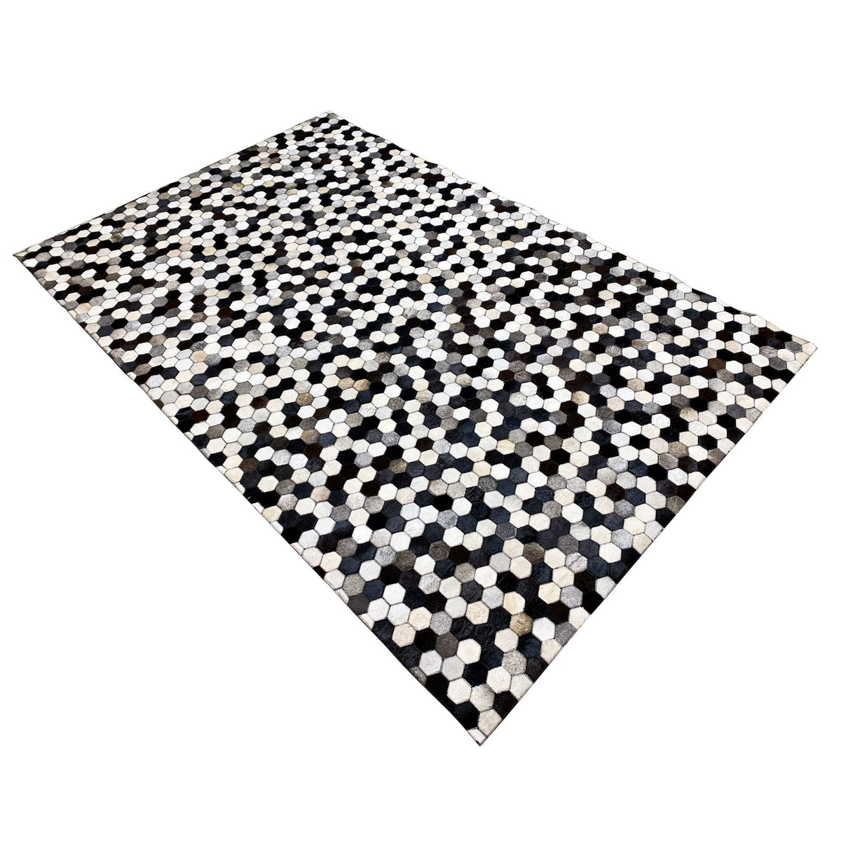 Calfskin rug, square-looking view with a hexagon pattern in black and off-white