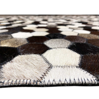 Close-up: hexagonal pattern with visible pile texture and a sewn carpet edge along the border