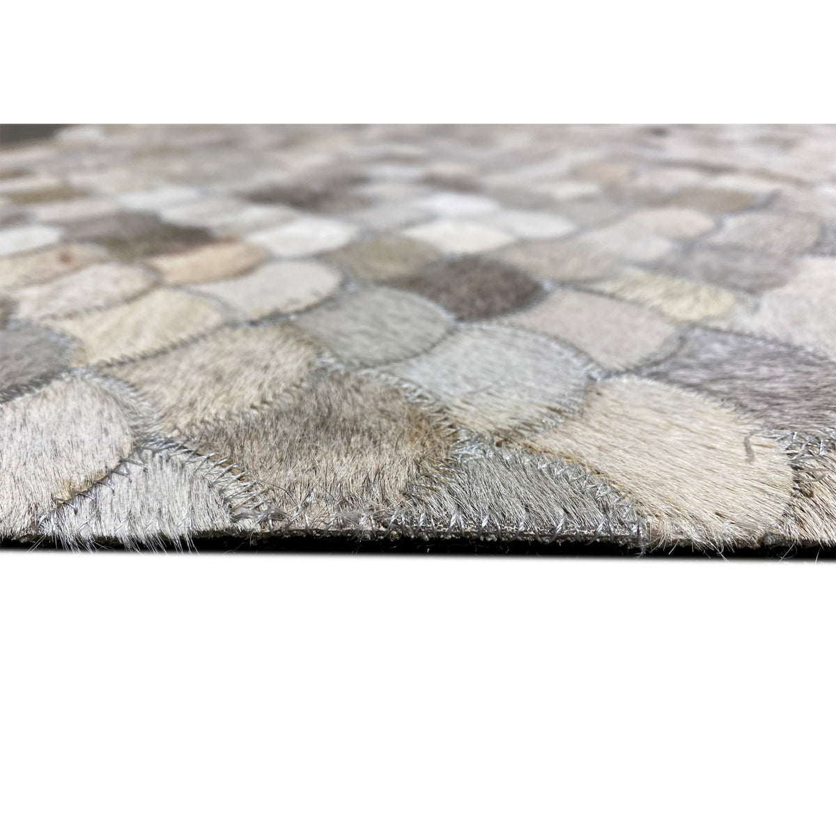 Beige and gray shell calfskin rug with fringed edges and a shell pattern