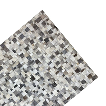 Calfskin rug with a diagonal view, tiled pattern in gray, cream, and black