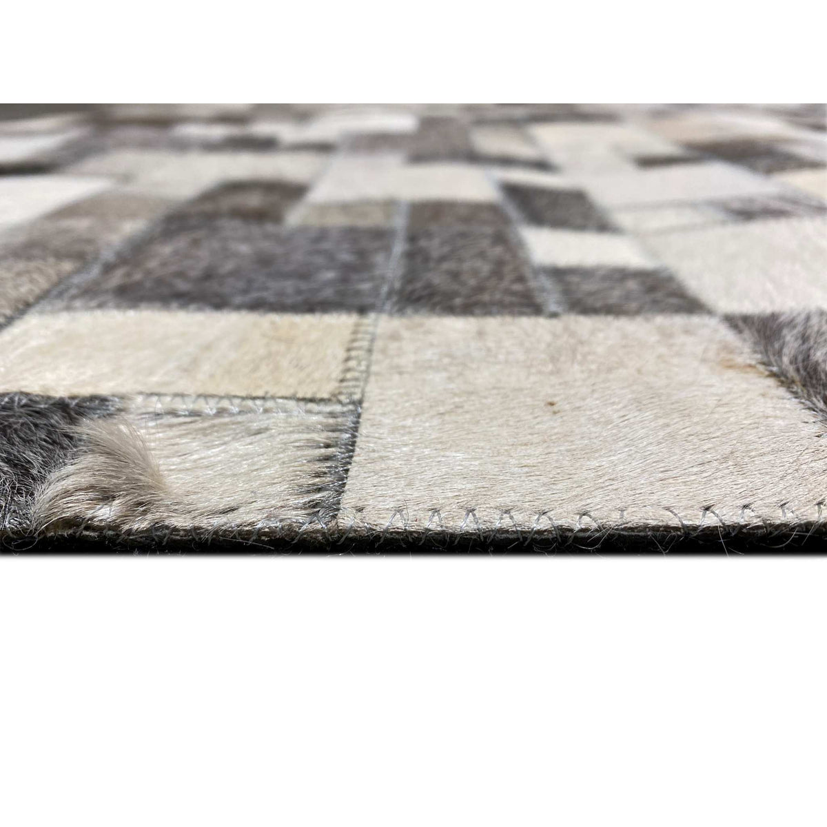 Calfskin rug detail at the edge with short pile and visible seam/cut edges