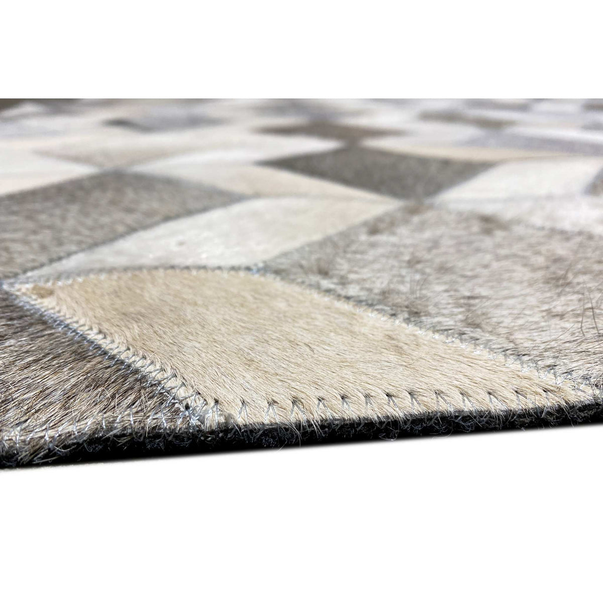 Rug edge with contrasting stitching and a short, dense pile surface