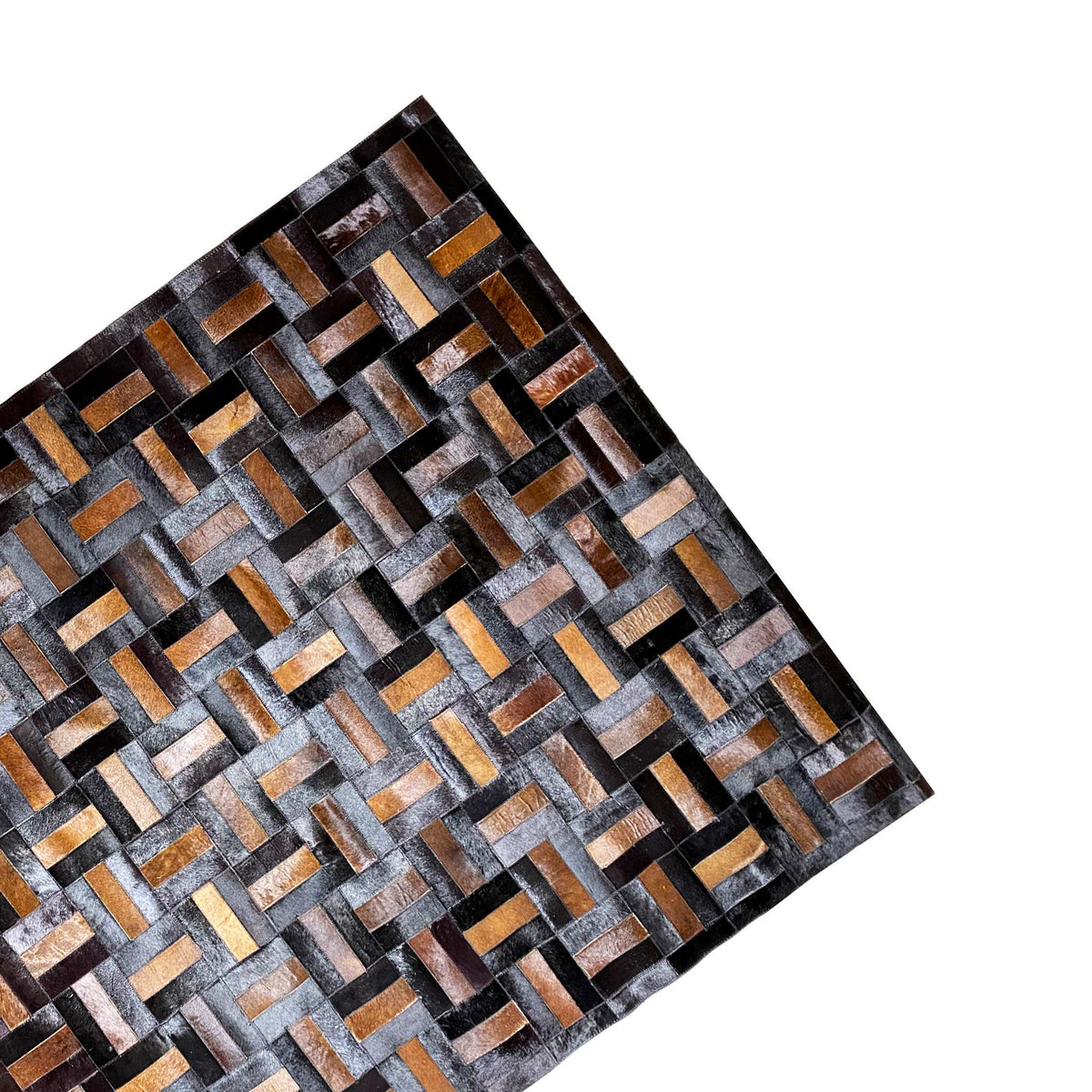 Leather rug close-up with brick and diamond patterns in black, gray, and ochre