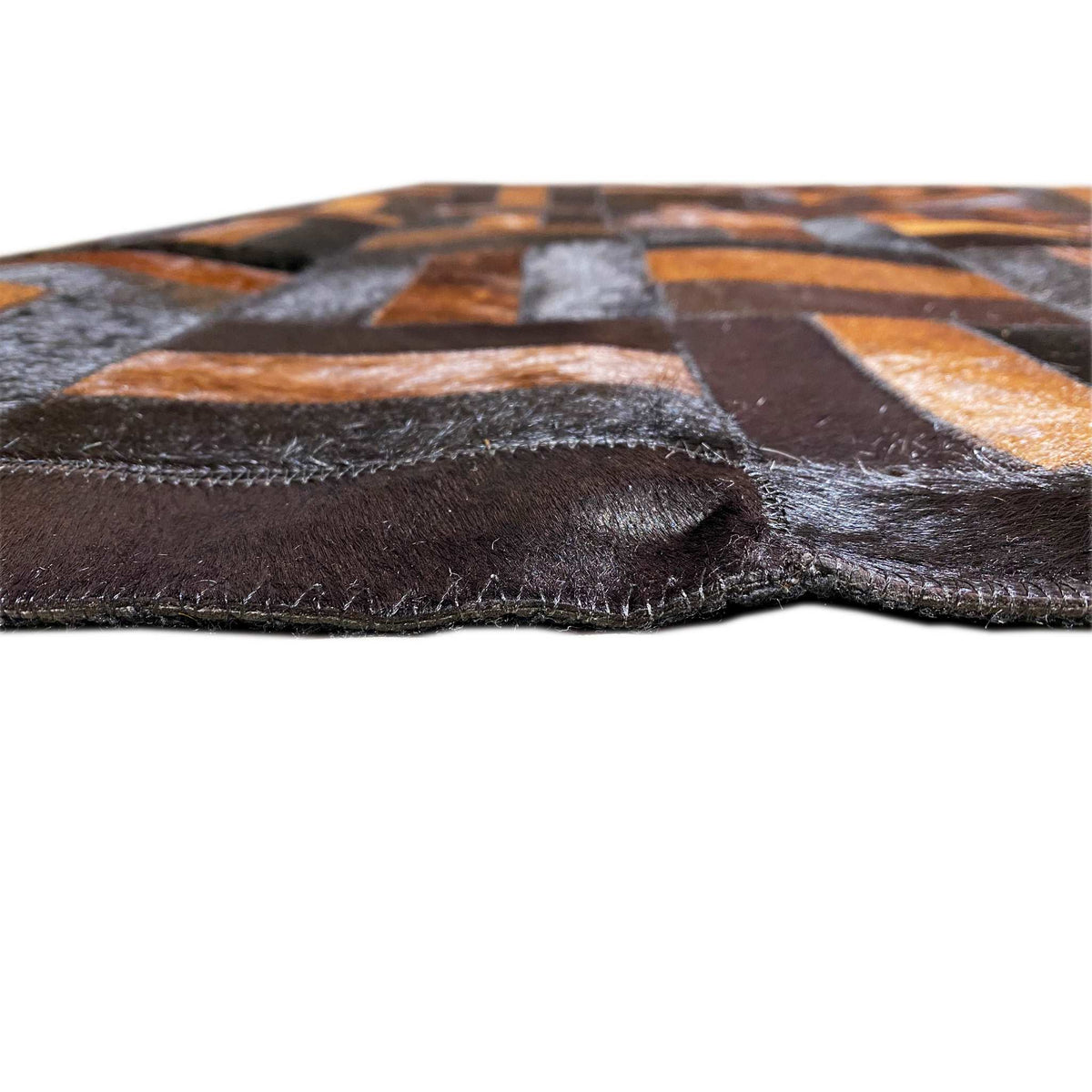 Leather rug edge view with a stitched leather edge and multilayer padding