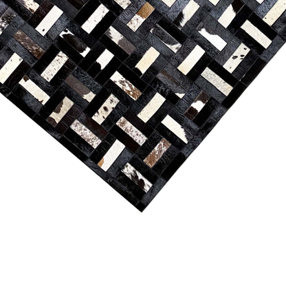 Calfskin rug with a black-gray and white zigzag block pattern, close-up
