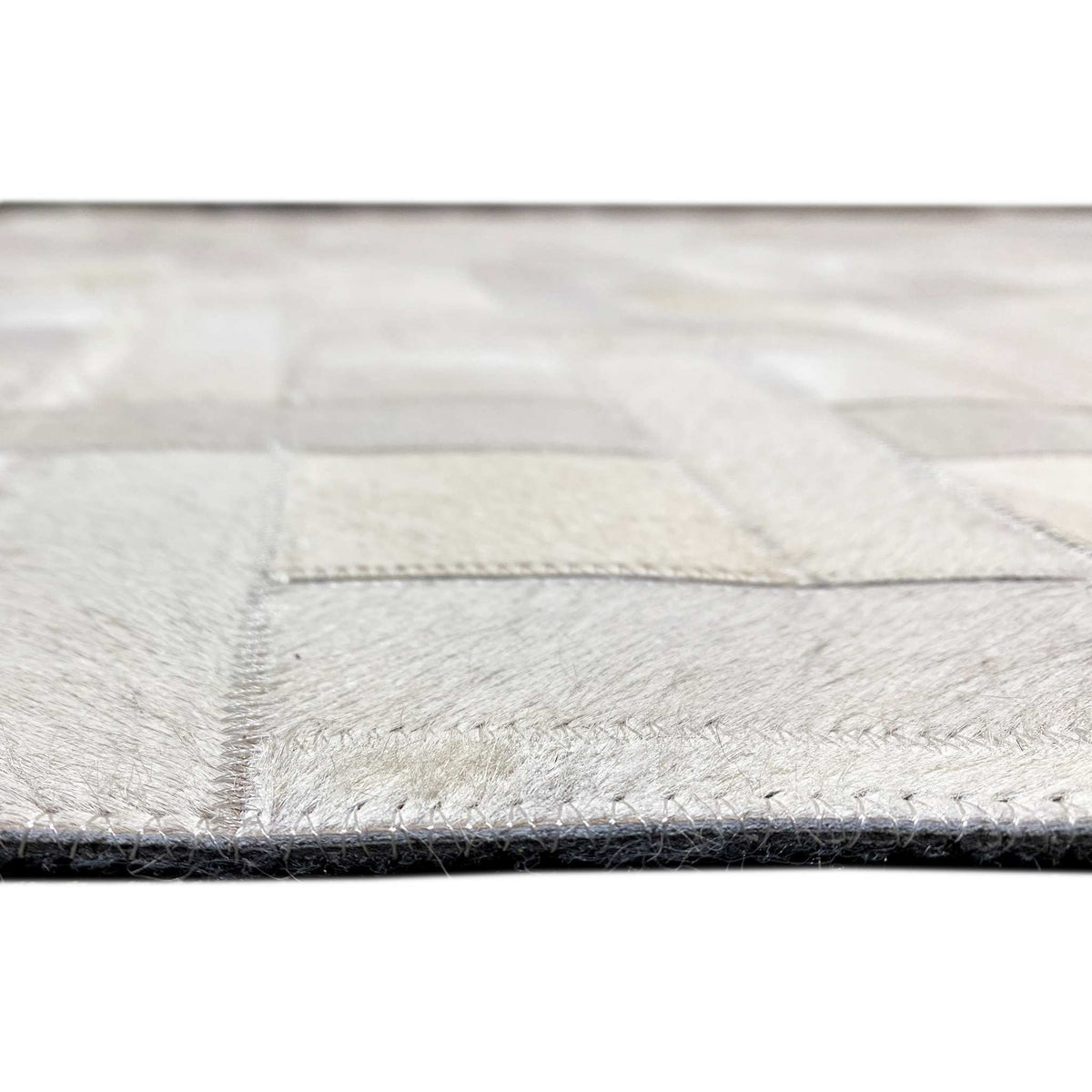 Leather rug edge with a finely contrasting seam and woven surface