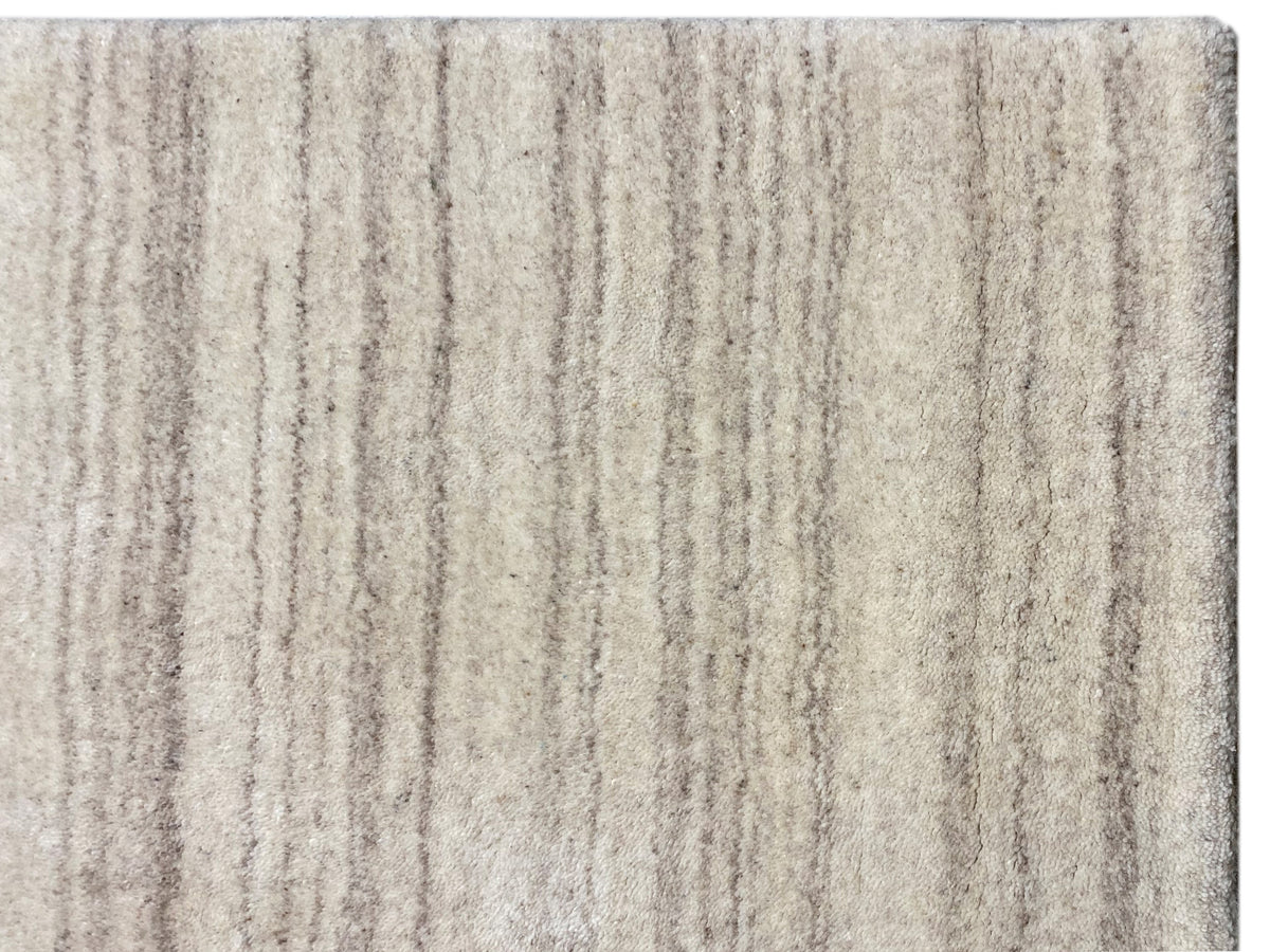 Close-up: carpet with a beige pile and fine vertical lines in a mélange look
