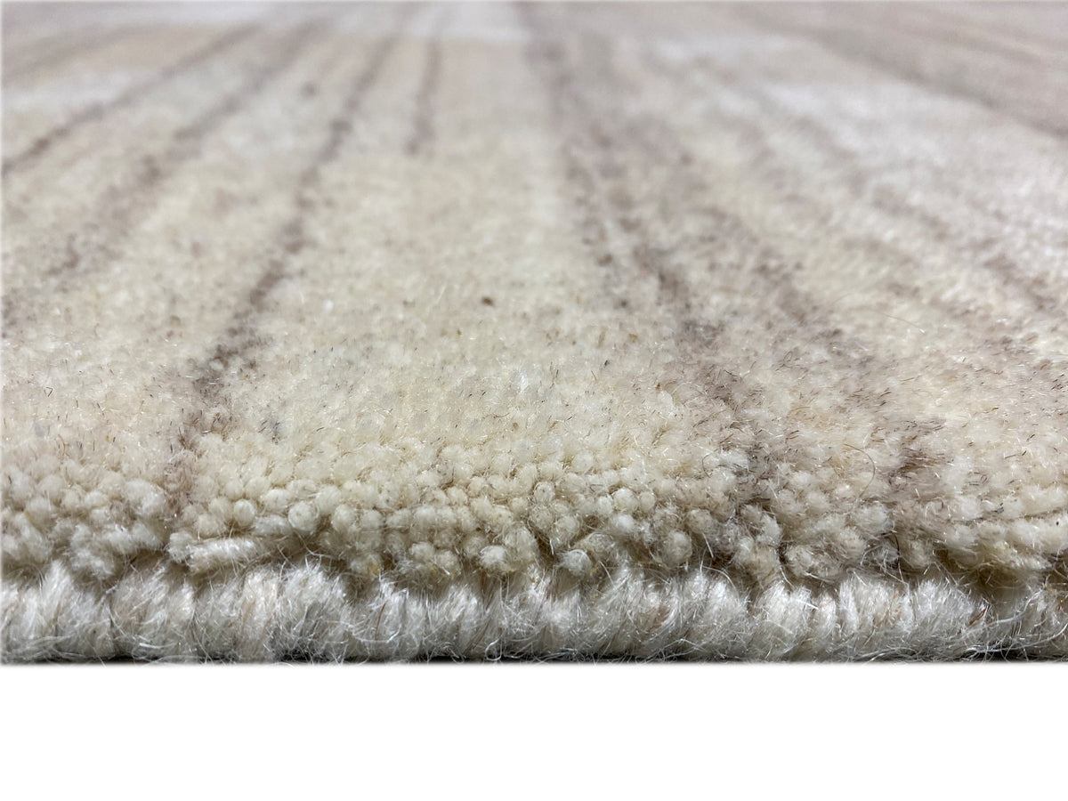 Carpet surface with a short pile and beige, mottled stripes