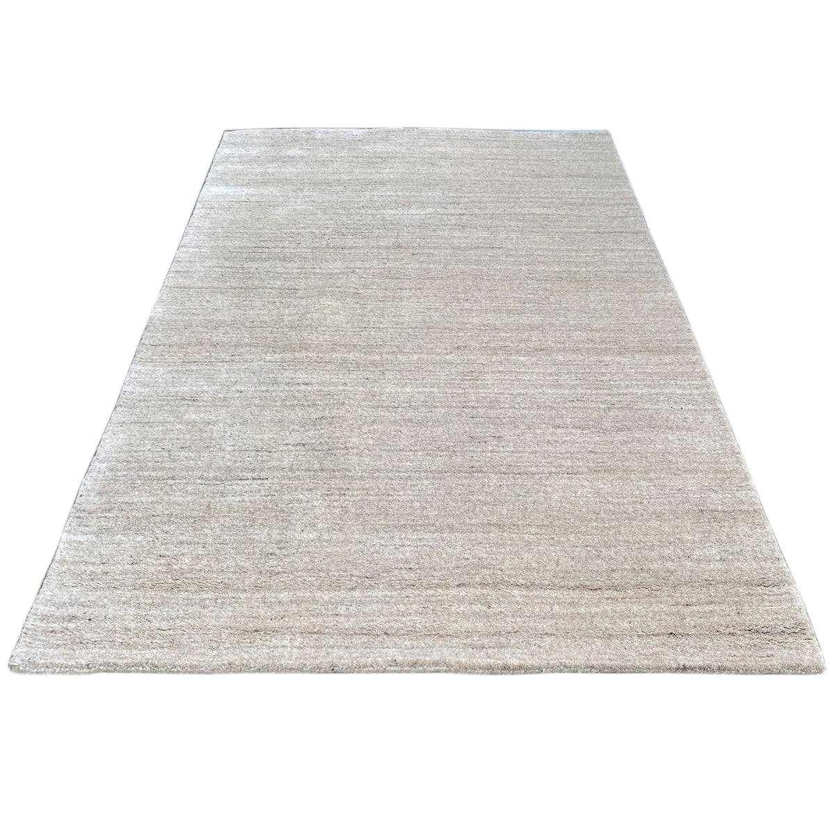 Rectangular rug in light beige with a fine, speckled woven texture