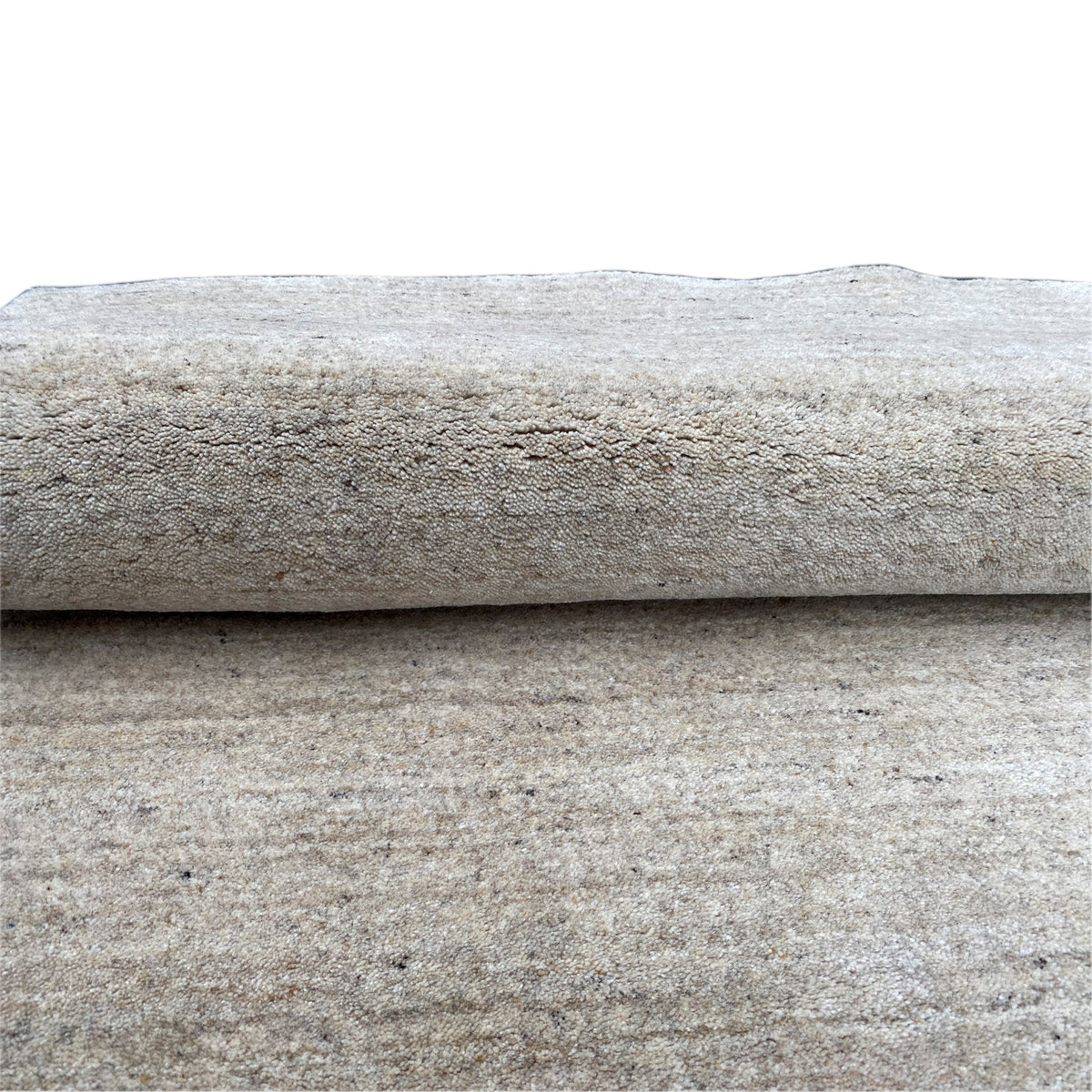 Detail: two layers of fabric/carpet edges overlapping, with a uniform mottled texture