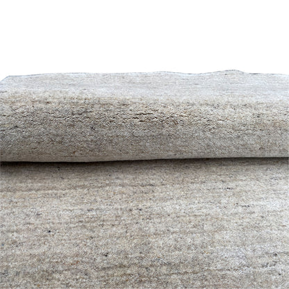 Detail: two layers of fabric/carpet edges overlapping, with a uniform mottled texture