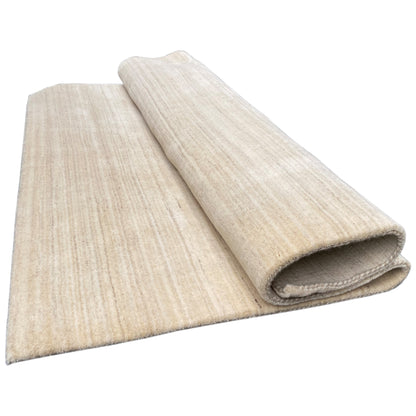 Natural gabbeh rug, rolled in two layers, light beige, pile and underside visible