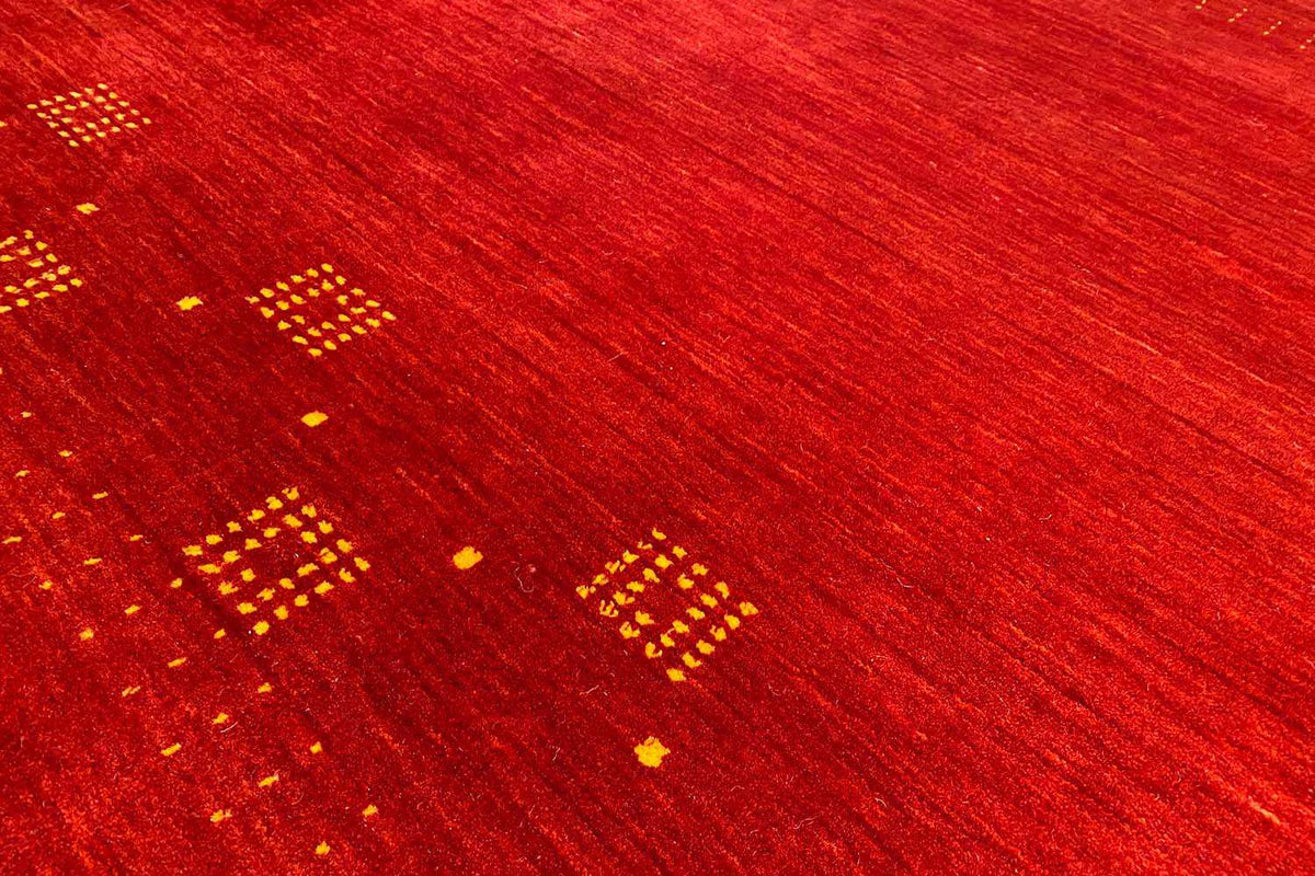 Red carpet with gold dot and diamond motifs, fine woven texture