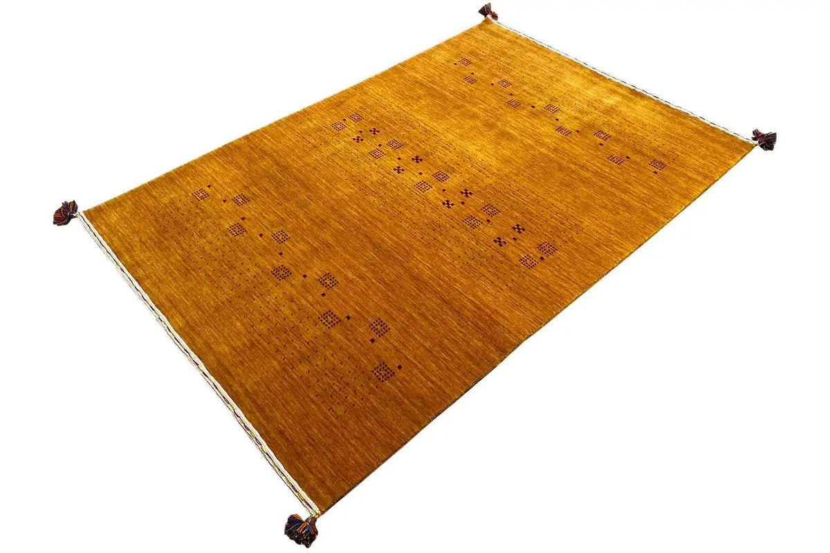 Gabbeh loom rug with an angled pattern and dark dotted squares, tassels