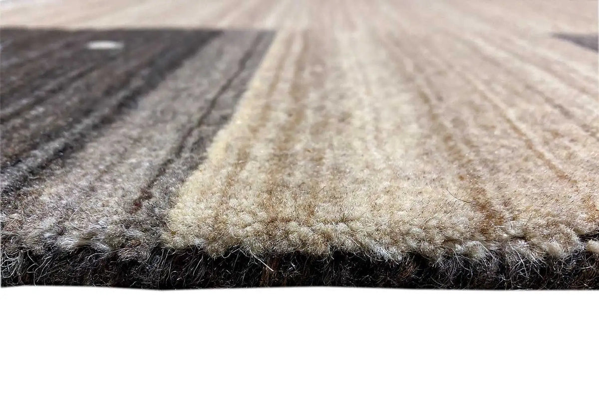 Carpet pile in close-up detail with a frayed edge; light strip and dark contrasting stripes