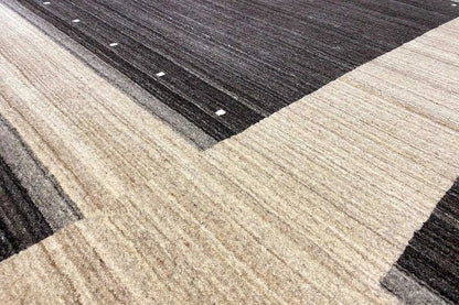 Geometric carpet pattern in detail: broad light cross shape with dark zones and dots