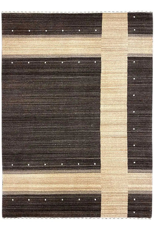 Rectangular rug with a framed pattern of dark and beige areas with dot accents