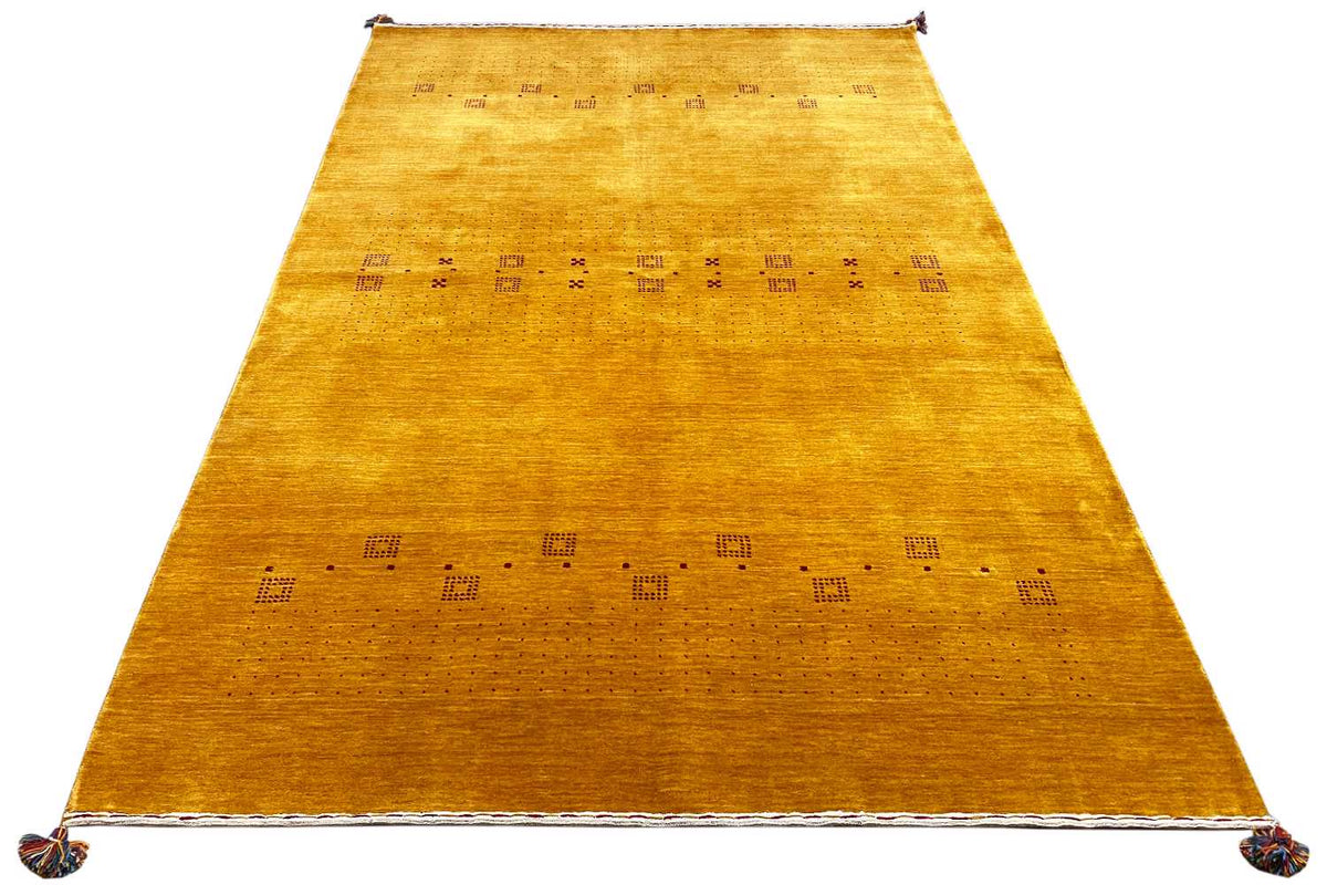 Gabbeh rug, honey-colored runner with a geometric pattern, visible at the fringes