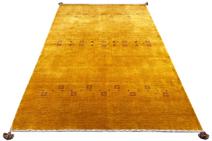Gabbeh rug, honey-colored runner with a geometric pattern, visible at the fringes