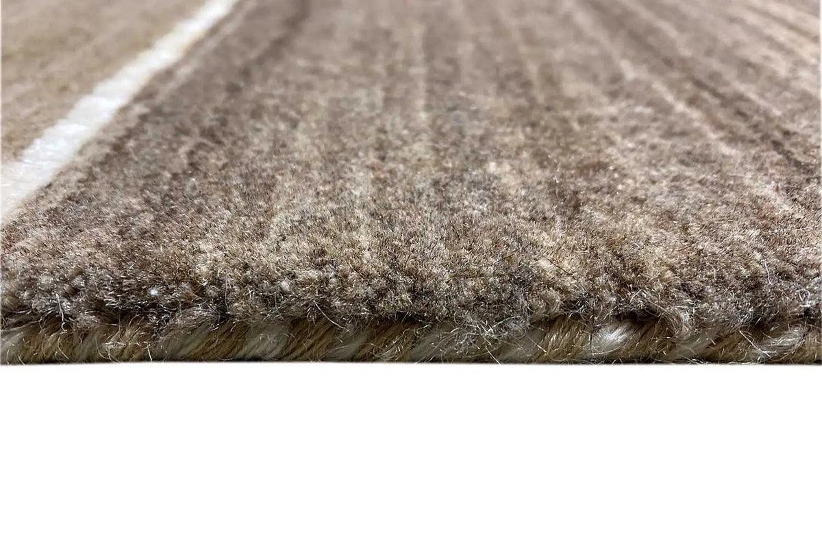 Gabbeh rug close-up of the edge: high pile, beige and brown with stripes