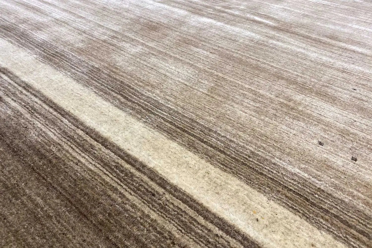 Gabbeh rug detail: horizontal stripes in cream, beige, and brown