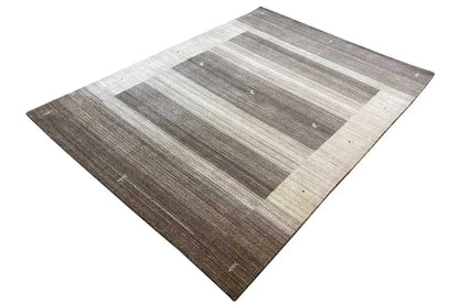 Rug in a diamond pattern with horizontal stripes in gray and beige, small light dots.