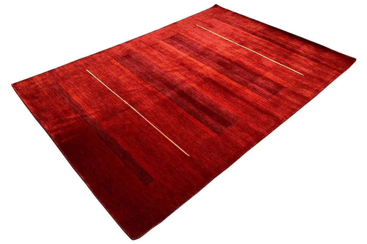 Gabbeh rug with linear patterns and blocks of color in red, top view