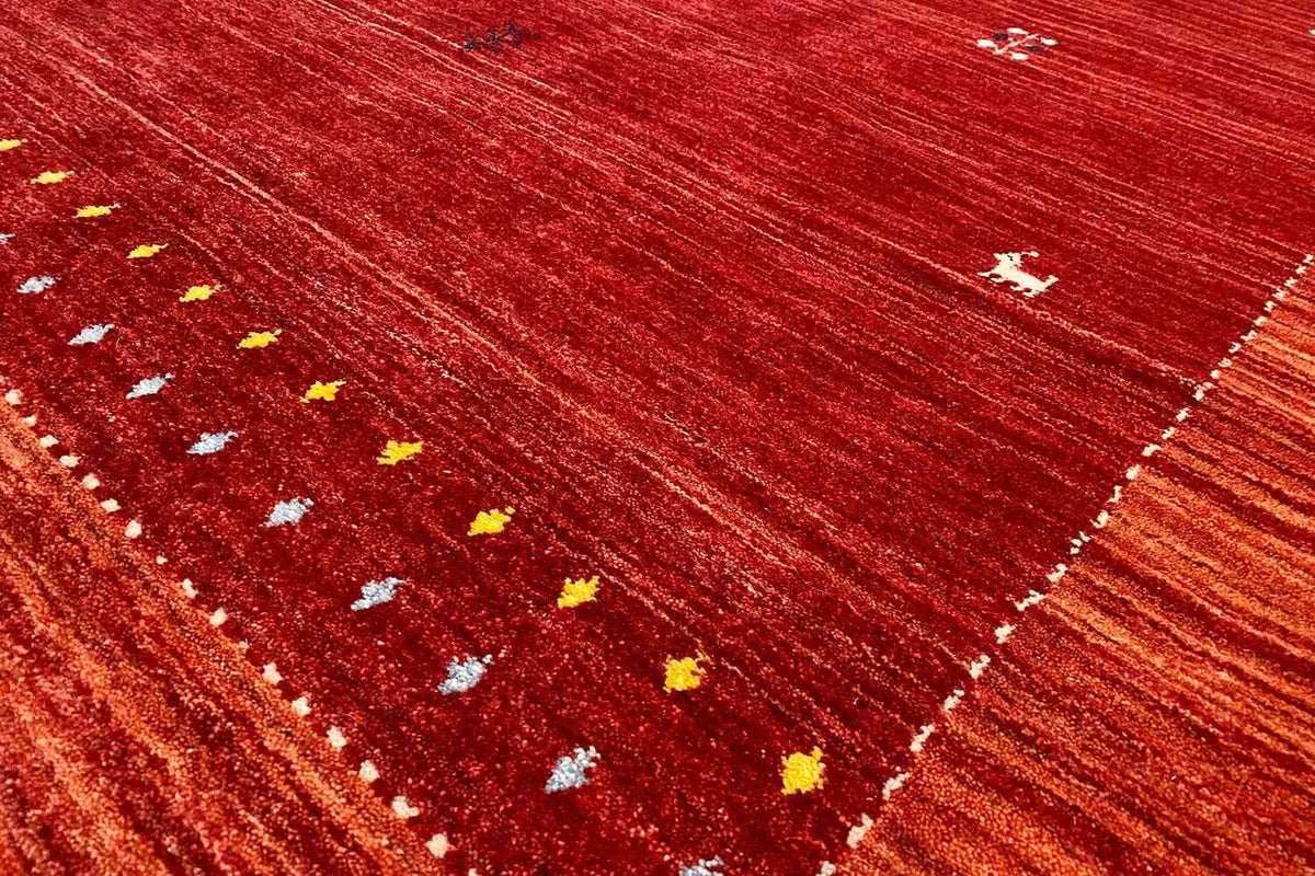 Gabbeh rug, border detail with small yellow-and-white dots on a red background