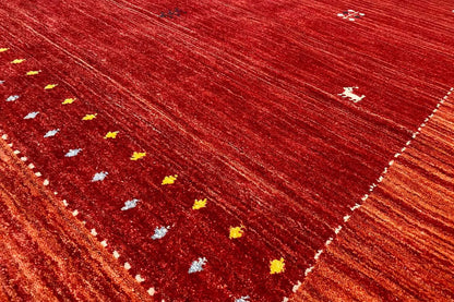 Gabbeh rug, border detail with small yellow-and-white dots on a red background