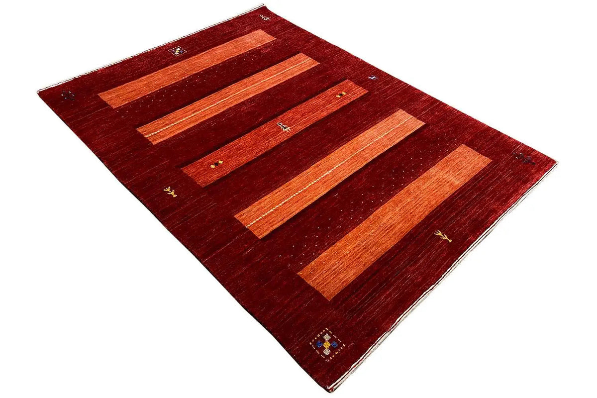 Gabbeh rug with a diagonal view: reddish brown with orange stripes and corner ornaments