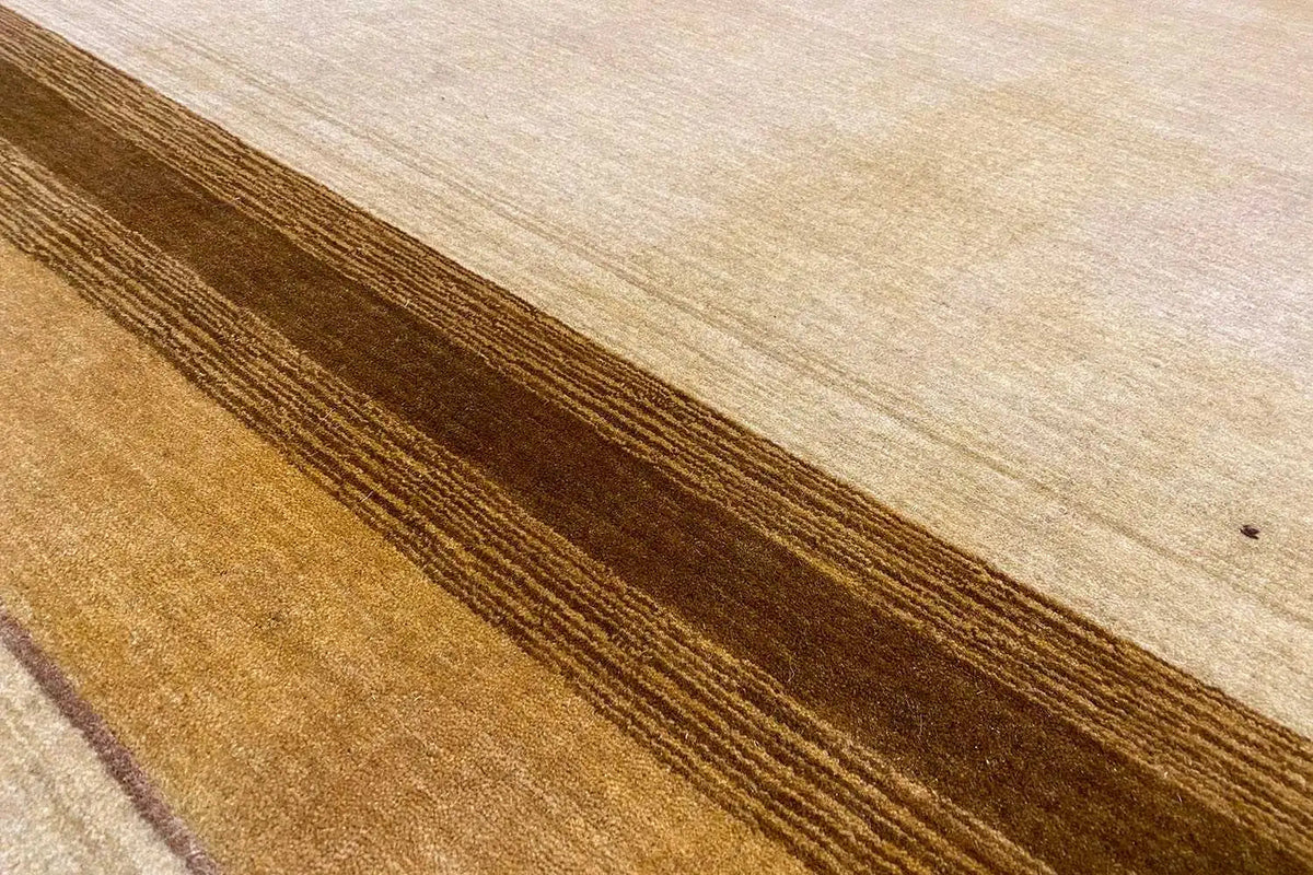 Carpet surface with a beige base and long brown stripes, tightly cropped