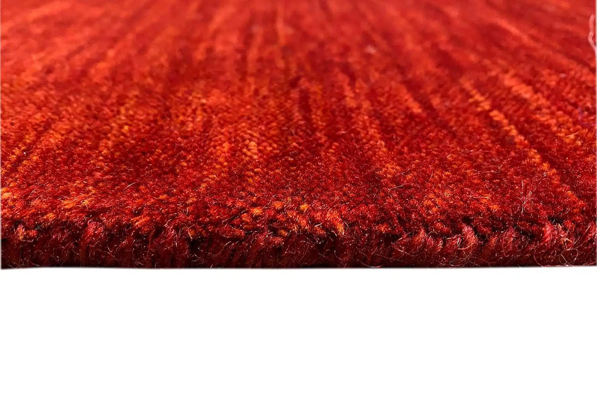 Gabbeh rug, red pile pattern with a dense border, close-up