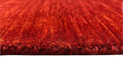 Gabbeh rug, red pile pattern with a dense border, close-up