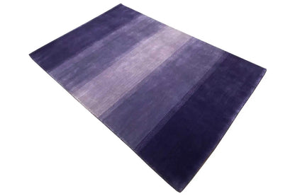 Gabbeh rug appearing square, placed at an angle, with blue/violet stripes.