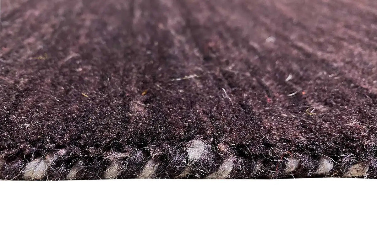 Pile of a Gabbeh rug, dark purple with a dense texture