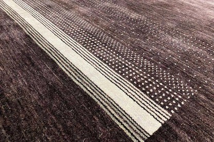 Close-up: dark purple Gabbeh rug with light lines and dotted pattern