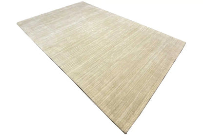 Gabbeh rug in light beige with a fine linear texture, laid diagonally