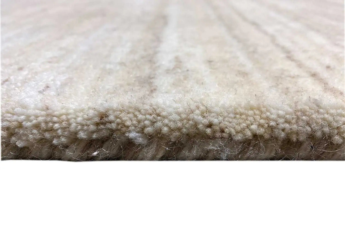 Gabbeh rug: pile and edge in light beige, close-up of the rug’s edge