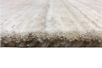 Gabbeh rug: pile and edge in light beige, close-up of the rug’s edge